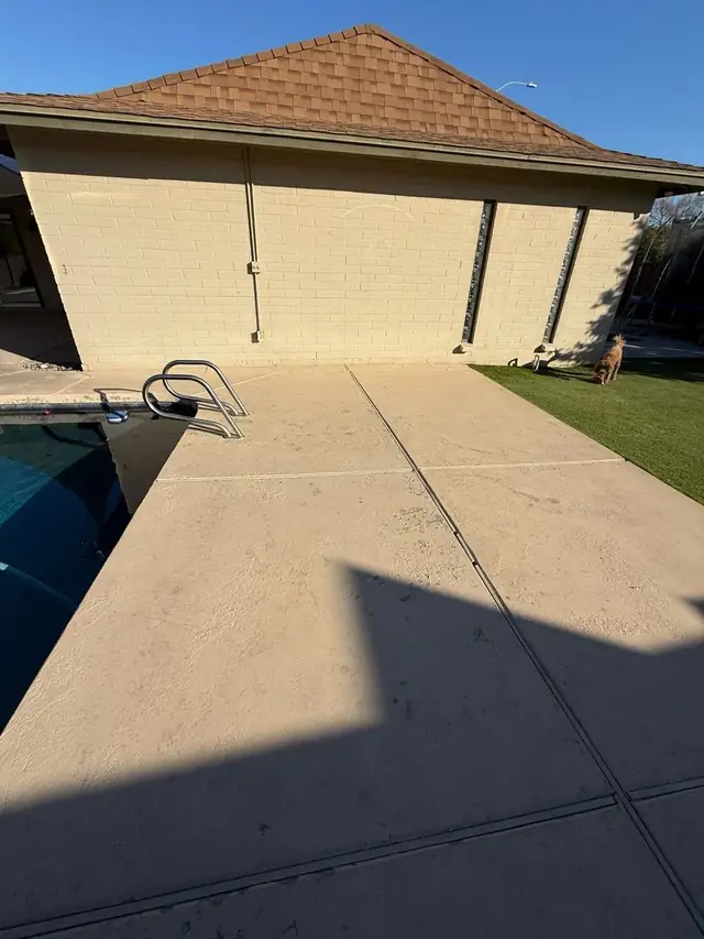 A finished cool deck wrapping a residential backyard pool in the Phoenix Valley