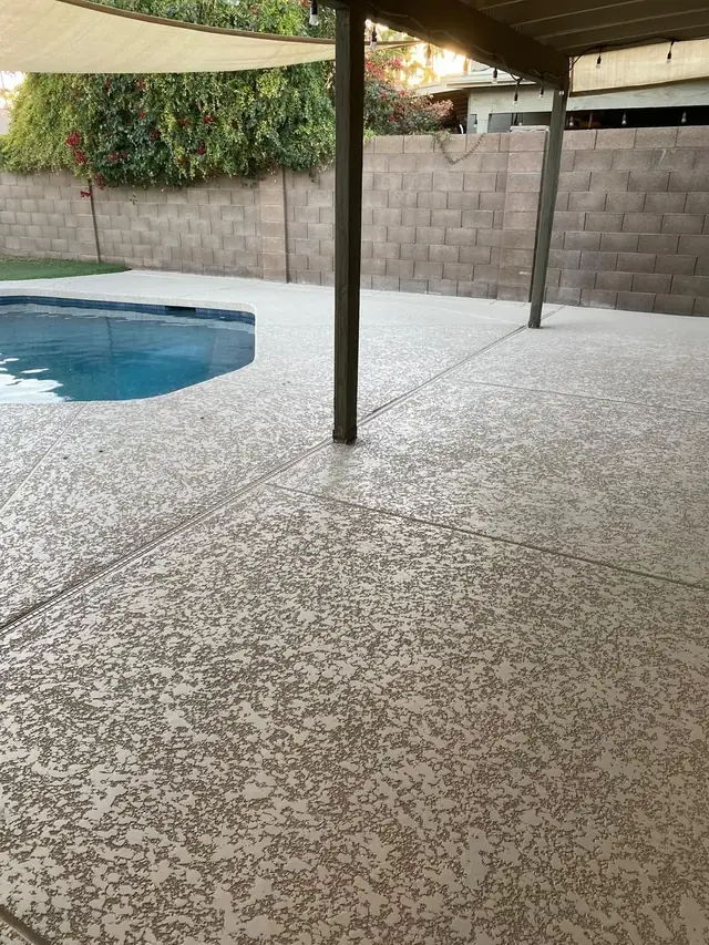Cool deck coating under a covered patio, continuing out to the pool surround